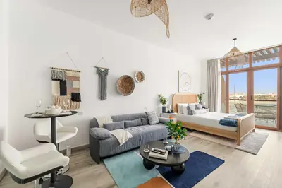 a living room with a couch and a bed at Silkhaus Sea View Studio in Palm Jumeirah in Dubai