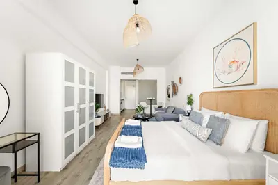 a living room with a large white bed and a couch at Silkhaus Sea View Studio in Palm Jumeirah in Dubai