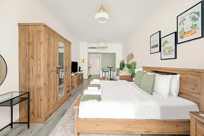 a bedroom with a large bed and a living room at Silkhaus Beach Access Studio in Palm Views East in Dubai