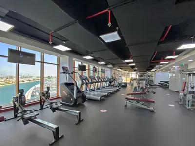 a gym with treadmills and machines in a building at Silkhaus Offshore Studio in Palm Views East Tower in Dubai