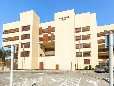 a building with a parking lot in front of it at Silkhaus Offshore Studio in Palm Views East Tower in Dubai