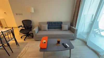 a living room with a couch and a table at Chic Marina Vibes 1BR Pad with Epic Views in Dubai