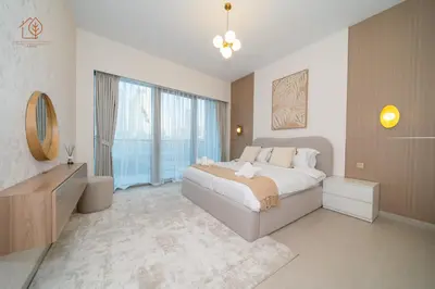 a bedroom with a large bed and a large window at Cozy 2-Bed Home with Burj Khalifa Views 204GR-2 in Dubai
