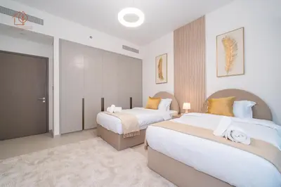 a bedroom with two beds and a sliding door at Cozy 2-Bed Home with Burj Khalifa Views 204GR-2 in Dubai
