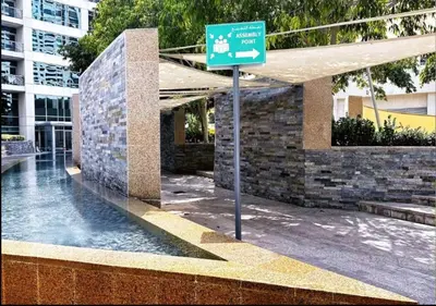 a green street sign in front of a building at Blakely 2BR Lakeview Retreat - Open Balcony and Marina Views in Dubai