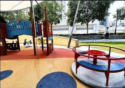 a playground with a table and a swing at Blakely 2BR Lakeview Retreat - Open Balcony and Marina Views in Dubai