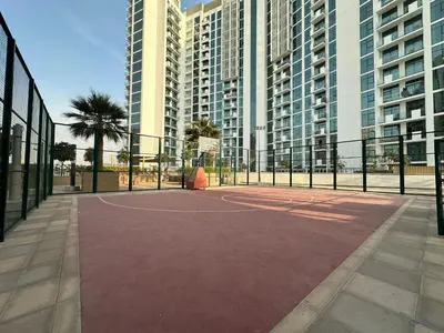 a basketball court in a city with tall buildings at Sunset Haven Chic Creek Studio in Dubai