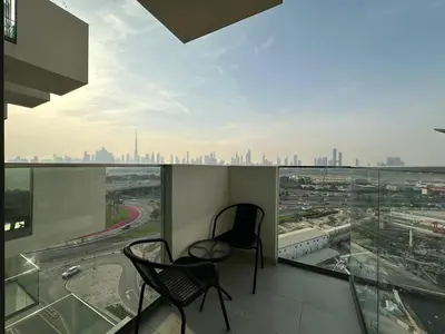 a balcony with two chairs and a view of a city at Sunset Haven Chic Creek Studio in Dubai