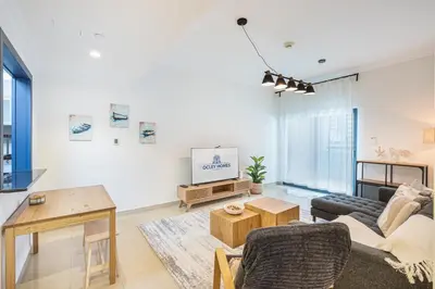 a living room with a couch and a tv at Elegant Home in the Heart of Marina in Dubai
