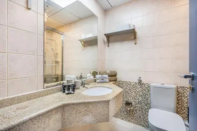 a bathroom with a sink and a toilet at Elegant Home in the Heart of Marina in Dubai