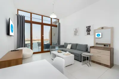 a living room with a couch and a table at Deluxe Waterfront Unit in Heart Of Dubai Palm Jumeirah in Dubai