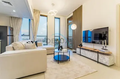a living room with a couch and a table at Charming 1BR in Dania 3, IMPZ by Deluxe Holiday Homes in Dubai