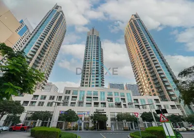 three tall buildings in a city with a street at Tranquil 1BR in Burj Views Tower B, Downtown by Deluxe Holiday Homes in Dubai