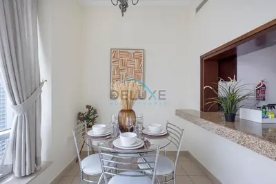 a dining room with a table and chairs at Tranquil 1BR in Burj Views Tower B, Downtown by Deluxe Holiday Homes in Dubai
