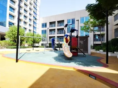 a playground in front of a building with a slide at Tranquil 1BR in Burj Views Tower B, Downtown by Deluxe Holiday Homes in Dubai