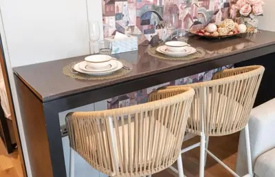 a table with two chairs and a table with plates and bowls at The Pretty Pad on The Palm! in Dubai