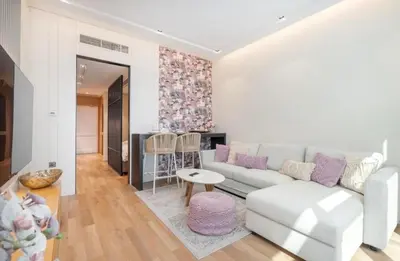 a living room with a couch and a table at The Pretty Pad on The Palm! in Dubai