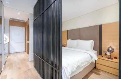 a bedroom with a large bed with a black wall at The Pretty Pad on The Palm! in Dubai