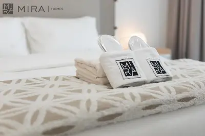 a bed with two towels on top of it at Mira Holiday Homes - Newly 2 bedroom with balcony in Business Bay in Dubai