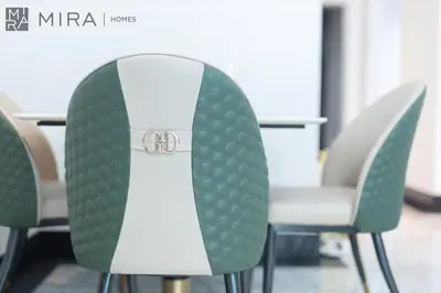 a set of green and white chairs in a meeting room at Mira Holiday Homes - Newly 2 bedroom with balcony in Business Bay in Dubai