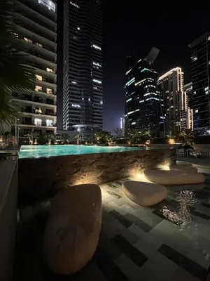 a view of a city skyline at night at Stylish 1BR in the heart of Dubai - easy walk by the canal in Dubai