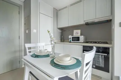 a kitchen with a table with two chairs and a microwave at Stylish 1BR in the heart of Dubai - easy walk by the canal in Dubai