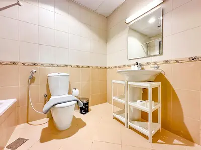 a bathroom with a toilet and a sink at Amazing 2 Bedroom in Al Rabia Tower in Majan 6PPL in Dubai