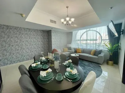 a living room with a table and a couch at Amazing 2 Bedroom in Al Rabia Tower in Majan 6PPL in Dubai