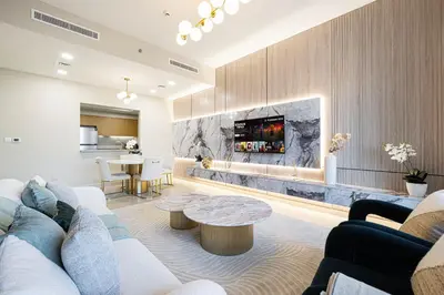 a living room with a couch and a table at Full Burj Khalifa View, TOP Floor, 5min Dubai Mall in Dubai
