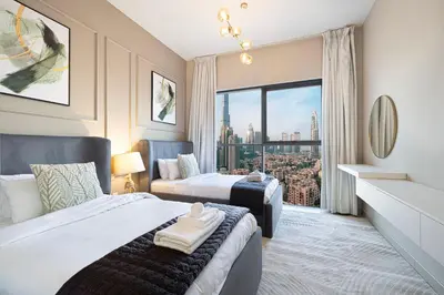 a bedroom with two beds and a large window at Full Burj Khalifa View, TOP Floor, 5min Dubai Mall in Dubai