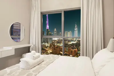 a bedroom with a large window with a city view at Full Burj Khalifa View, TOP Floor, 5min Dubai Mall in Dubai
