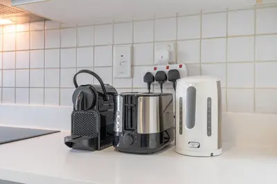a kitchen counter with a coffee maker and a toaster at Beachfront Bliss Luxurious 3-BR Stay in JBR in Dubai