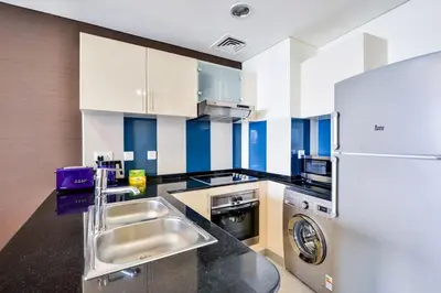 a kitchen with a sink and a refrigerator at Luxury Sea View apartment in Dubai