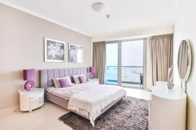 a bedroom with a bed and a large window at Luxury Sea View apartment in Dubai