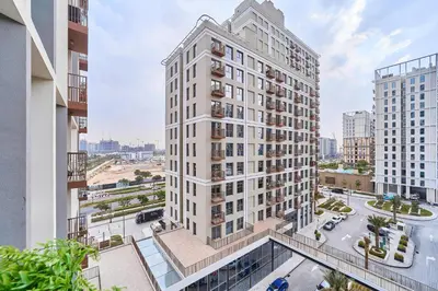 an aerial view of a tall white building at Elegant 2BR Living Steps from Dubai Hills Park in Dubai