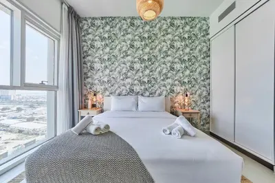 a bedroom with a bed with two stuffed animals on it at Elegant & Bright 1BR Getaway Near Dubai Hills Park in Dubai
