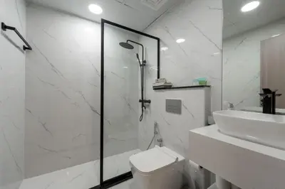 a bathroom with a shower and a toilet and a sink at Dubai Marina - 1 BHK Elegant Apartment in Dubai