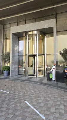 a woman standing outside of a building with her luggage at Full Burj Khalifa & Fountain Views Attached to Dubai Mall in Dubai