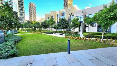 a park in the middle of a city with tall buildings at Full Burj Khalifa & Fountain Views Attached to Dubai Mall in Dubai