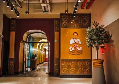a sign on the wall of a building with a picture of a chef at Full Burj Khalifa & Fountain Views Attached to Dubai Mall in Dubai