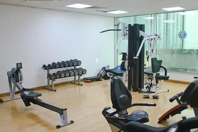 a gym with a bunch of exercise bikes in it at 2 Bedroom Apartment with Spacious Private Garden in Dubai Marina in Dubai