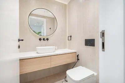 a bathroom with a sink and a mirror at StayShort - Bright and Airy 1-Bedroom Apartment Perfect for 4 in Dubai Marina in Dubai