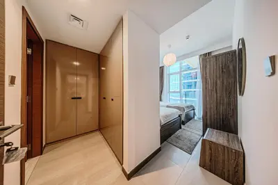 a bedroom with a bed and a walk in closet at 2BR apartment in Missoni in Dubai