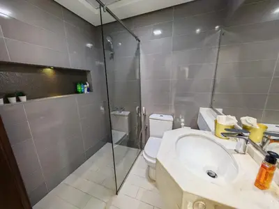 a bathroom with a toilet and a sink and a shower at Silicon Heights II in Dubai