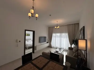 a living room with a couch and a mirror at Silicon Heights II in Dubai