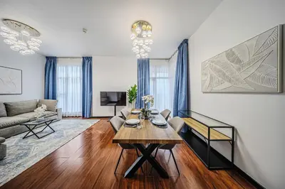a living room with a table and a couch at Amazing 1BR apartment near metro station in JLT in Dubai