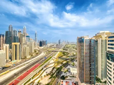 a view of a city with traffic on a highway at Amazing 1BR apartment near metro station in JLT in Dubai