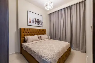 a bedroom with a large bed in front of a window at stylish 2 bedroom Apt in Business bay Dubai in Dubai