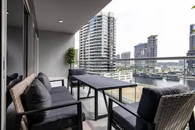 a balcony with a table and chairs and a large window at stylish 2 bedroom Apt in Business bay Dubai in Dubai