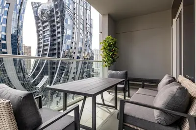 a balcony with a table and chairs and a large window at stylish 2 bedroom Apt in Business bay Dubai in Dubai
